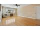 Large bonus room with hardwood floors, neutral paint, and natural light at 606 N Mcdonald St, Mount Dora, FL 32757