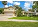 Charming two-story home with well-maintained lawn and lush landscaping at 606 N Mcdonald St, Mount Dora, FL 32757