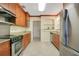 Galley kitchen with stainless steel appliances and granite countertops at 606 N Mcdonald St, Mount Dora, FL 32757
