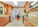 Kitchen with granite countertops, stainless steel appliances, and cherry wood cabinetry at 606 N Mcdonald St, Mount Dora, FL 32757