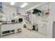 Organized laundry room with shelving and a utility sink, providing ample storage and convenience for household tasks at 606 N Mcdonald St, Mount Dora, FL 32757
