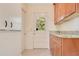 Mud room with granite countertops and white cabinetry at 606 N Mcdonald St, Mount Dora, FL 32757
