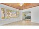 Sun room with tile flooring, wood ceiling, many windows, and view to the living room at 606 N Mcdonald St, Mount Dora, FL 32757