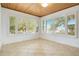 Bright sunroom with tile floors, wood ceilings, and large windows with shutter blinds allowing natural light to shine through at 606 N Mcdonald St, Mount Dora, FL 32757