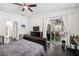Bedroom features hardwood floors, fan, and sliding glass doors to the screened-in lanai at 6080 Fender Ct, Orlando, FL 32837