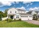 Beautiful two-story home with a three car garage, brick paver driveway and lush landscaping at 6080 Fender Ct, Orlando, FL 32837