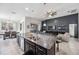 Open-concept kitchen with a granite island overlooking the living room and outdoor patio at 6080 Fender Ct, Orlando, FL 32837