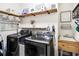Laundry room with washer, dryer, storage shelves, laundry rules sign, and sink at 6080 Fender Ct, Orlando, FL 32837