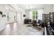 Open-concept living room with tile floors, piano, and an elegant chandelier at 6080 Fender Ct, Orlando, FL 32837