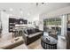 Open-concept living room with a view into the kitchen and outdoor patio at 6080 Fender Ct, Orlando, FL 32837