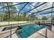 Beautiful screened-in pool and spa with lush landscaping and clear blue water at 6080 Fender Ct, Orlando, FL 32837