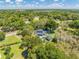 Aerial view captures the house nestled among lush trees and greenery, offering a sense of privacy and tranquility at 6464 Timberwind Pl, Orlando, FL 32818