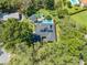 Aerial view showcasing a backyard oasis with a pool, patio, and lush greenery at 6464 Timberwind Pl, Orlando, FL 32818