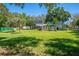 Expansive backyard featuring a lush lawn, mature trees, and a patio area, creating an ideal space for outdoor enjoyment at 6464 Timberwind Pl, Orlando, FL 32818