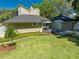 Well-manicured backyard with lush greenery and cozy outdoor seating area at 6464 Timberwind Pl, Orlando, FL 32818