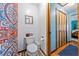 Half bathroom with toilet, decorative mirror and tiling detail next to the bedroom at 6464 Timberwind Pl, Orlando, FL 32818