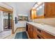 Well-maintained bathroom with wooden cabinets, solid surface countertop, and tiled floors at 6464 Timberwind Pl, Orlando, FL 32818
