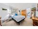 Bright bedroom with natural light, neutral walls, and a glimpse into an ensuite bathroom at 6464 Timberwind Pl, Orlando, FL 32818