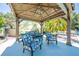 Cozy cabana with ample seating, tropical mural, and nearby pool at 6464 Timberwind Pl, Orlando, FL 32818