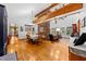 Spacious dining room featuring wood floors and a brick fireplace at 6464 Timberwind Pl, Orlando, FL 32818
