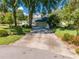 Large driveway leading to a well-maintained home with an attached garage at 6464 Timberwind Pl, Orlando, FL 32818
