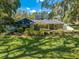 Beautiful single-Gathering home featuring manicured landscaping, mature trees, and a well-maintained lawn at 6464 Timberwind Pl, Orlando, FL 32818