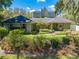 Charming front exterior showcasing the landscaping and inviting entrance at 6464 Timberwind Pl, Orlando, FL 32818