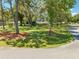 Scenic view of a lush front yard featuring mature trees providing ample shade and enhancing curb appeal of the home at 6464 Timberwind Pl, Orlando, FL 32818