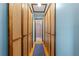 Hallway with closet storage leading to a bathroom with tiled shower at 6464 Timberwind Pl, Orlando, FL 32818