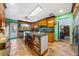 Well-lit kitchen featuring wooden cabinets, an island, and stainless steel appliances at 6464 Timberwind Pl, Orlando, FL 32818