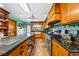Bright kitchen features tiled backsplash, stainless steel appliances, and wooden cabinetry at 6464 Timberwind Pl, Orlando, FL 32818