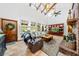 Inviting living room featuring a vaulted ceiling, brick fireplace, and abundant natural light at 6464 Timberwind Pl, Orlando, FL 32818