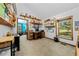Bright home office with built-in shelving, wooden desk, and a large window offering natural light at 6464 Timberwind Pl, Orlando, FL 32818