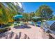 Outdoor living space featuring a brick patio with lounge chairs and a built-in grill at 6464 Timberwind Pl, Orlando, FL 32818