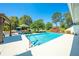 Sparkling pool surrounded by patio, lush landscaping, and a charming pergola at 6464 Timberwind Pl, Orlando, FL 32818