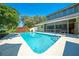 Backyard featuring pool, screened in patio and lush landscaping at 6464 Timberwind Pl, Orlando, FL 32818