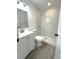 Renovated bathroom featuring a tiled shower and updated sink vanity at 709 28Th Nw St, Winter Haven, FL 33881
