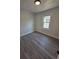 Small bedroom showcasing wood-look floors and a single window at 709 28Th Nw St, Winter Haven, FL 33881