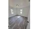 Well-lit bedroom showcasing wood-look floors and two windows at 709 28Th Nw St, Winter Haven, FL 33881