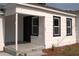 A close up exterior shot of the main entrance with black trimmed windows at 709 28Th Nw St, Winter Haven, FL 33881