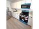 An interior kitchen view showcasing new white cabinets, quartz countertops, and new appliances at 709 28Th Nw St, Winter Haven, FL 33881