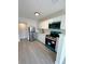 An interior kitchen view showing new appliances, white cabinets, and new flooring at 709 28Th Nw St, Winter Haven, FL 33881