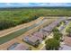 Beautiful aerial view of the home with a screened-in pool overlooking a canal and lush greenery at 8571 La Isla Dr, Kissimmee, FL 34747