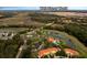 Aerial view showcasing a community with pool, lakes, palm trees, and easy access to Walt Disney World at 8571 La Isla Dr, Kissimmee, FL 34747
