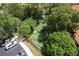 Aerial view of a beautifully designed miniature golf course winding through mature trees and landscaping at 8571 La Isla Dr, Kissimmee, FL 34747