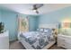 Inviting bedroom filled with natural light, complemented by a ceiling fan for a comfortable ambiance at 8571 La Isla Dr, Kissimmee, FL 34747