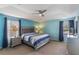 Comfortable bedroom with plush carpeting, a ceiling fan, and large windows for natural light at 8571 La Isla Dr, Kissimmee, FL 34747
