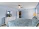 Bedroom featuring bright walls, ensuite bathroom and king bed at 8571 La Isla Dr, Kissimmee, FL 34747