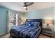 Cozy bedroom featuring a window view, ceiling fan, and nightstands at 8571 La Isla Dr, Kissimmee, FL 34747