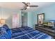 Inviting bedroom featuring an ensuite bathroom, ceiling fan, and dresser at 8571 La Isla Dr, Kissimmee, FL 34747